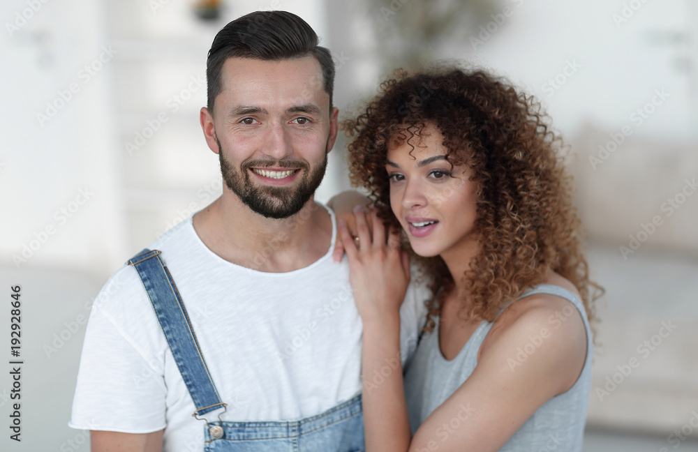 Happy young people standing in a new house