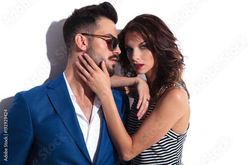 romantic woman holds palm on man's face