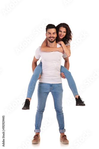 young man carries woman on his back