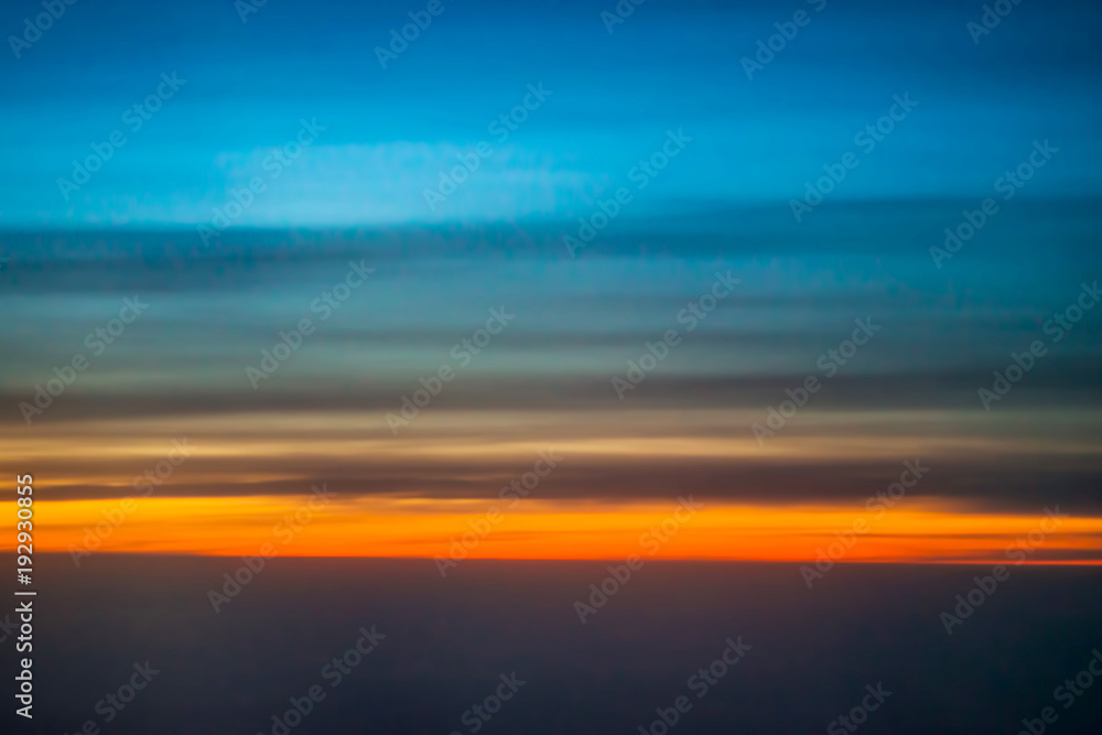 Dark sky blue and red from the window of the plane in the early morning at sunrise, landscape