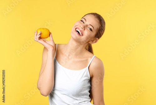 Beautiful young woman with ripe lemon on color background © Africa Studio