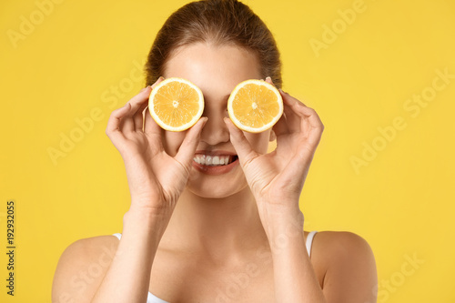 Young woman with halves of ...