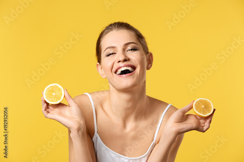 Young woman with halves of ...
