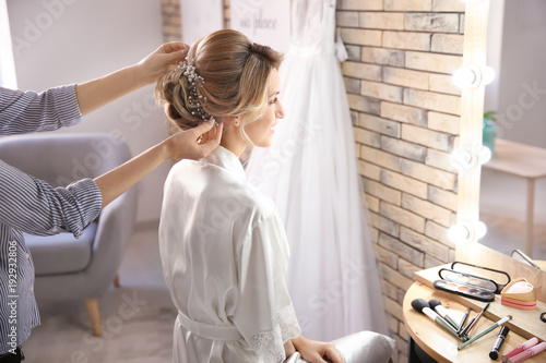 Hairdresser preparing bride...
