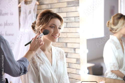 Makeup artist preparing bri...