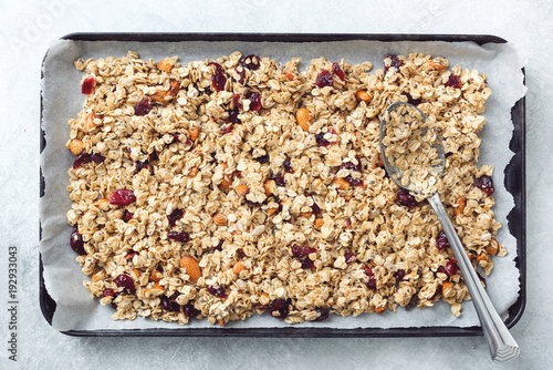 Homemade granola on baking sheet. Table top view. Concept of healthy eating, dieting, healthy lifestyle and wellness