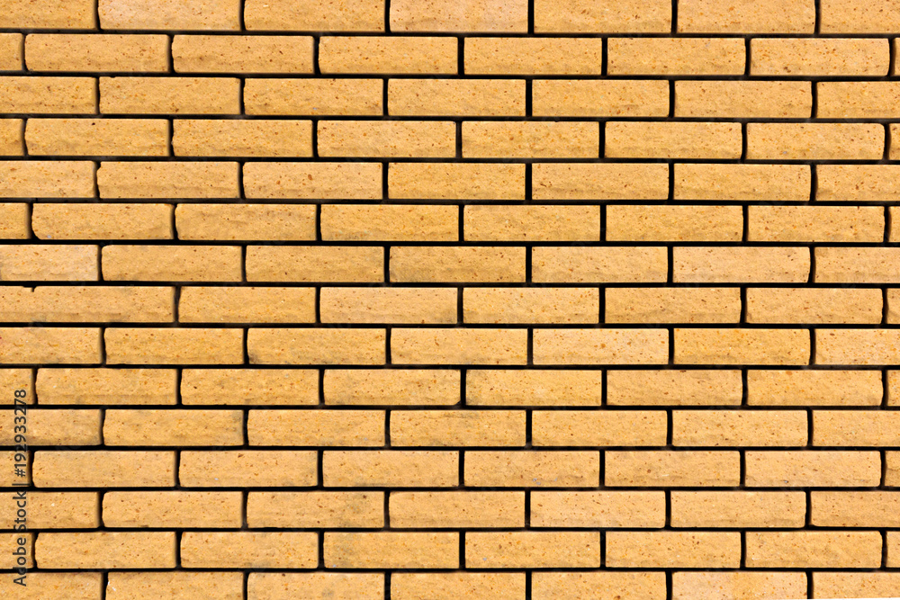 Brick wall. The brick wall painted in yellow Brick wall. The brick wall painted in yellow