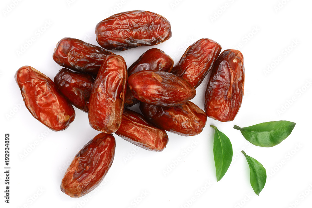 dry dates with green leaves isolated on white background. Top view. Flat lay pattern dry dates with green leaves isolated on white background. Top view. Flat lay pattern