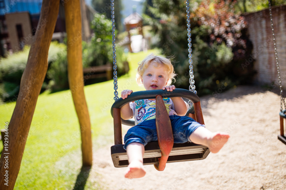Little boy on the swing at the playground. Little boy on the swing at the playground.