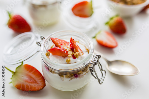 Delicious yogurt with e fresh strawberries and granola. 