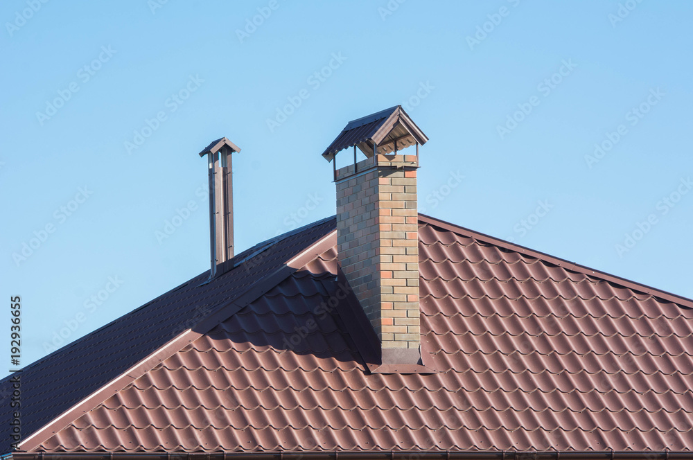 Chimneys on the roof under clear blue sky