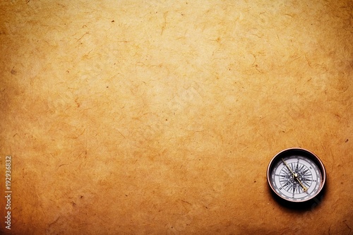 Close up view of the Compass on the old paper background