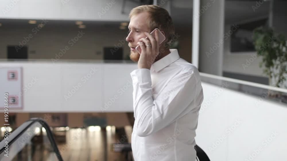 businessman talking on the phone in the business center businessman talking on the phone in the business center