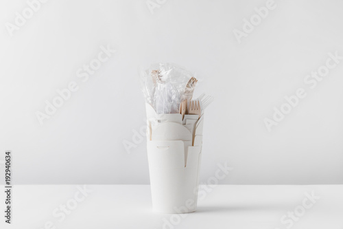 plastic forks in white take away boxes on table