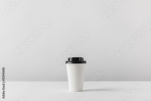 disposable coffee cup on white tabletop