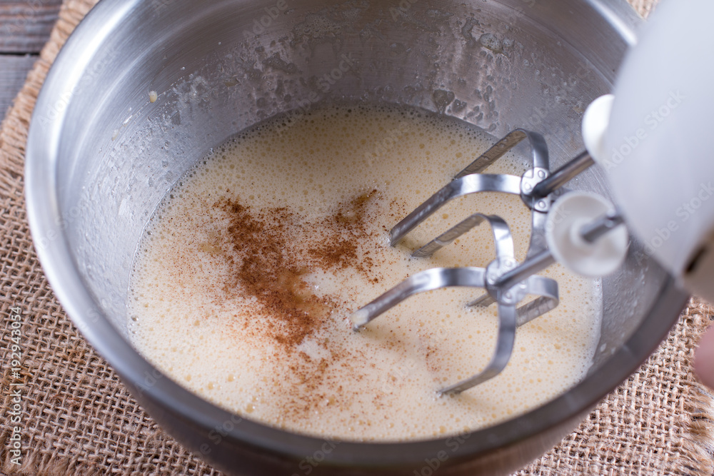 Cooking, whipping eggs with electric whisk in bowl Cooking, whipping eggs with electric whisk in bowl
