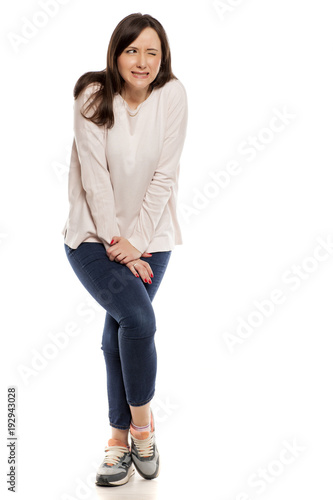 Photography young woman need a toilet on white background
