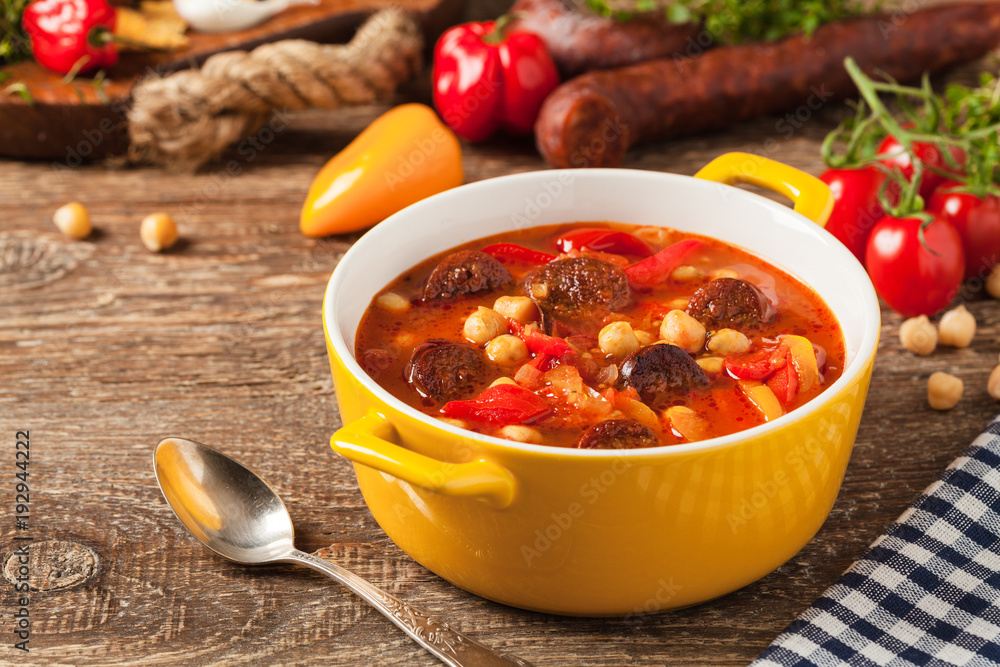 Traditional chickpea soup with paprika and chorizo sausage. Traditional chickpea soup with paprika and chorizo sausage.