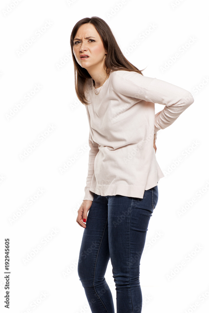 young woman with back pain on white background young woman with back pain on white background