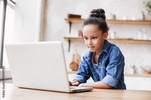 Cute little girl using laptop at home, Education, online study, home studying, distance learning, homework, schoolgirl children lifestyle concept