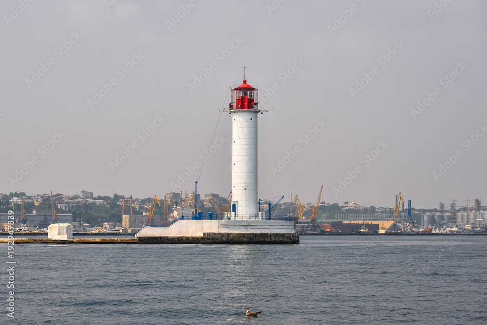 Odessa, Ukraine - August 25, 2016: View on beautiful white lighthouse - symbol of Odessa, Ukraine. Port, Black Sea and lighthouse.