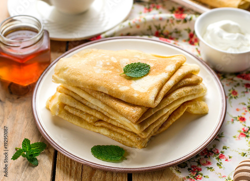 Photography Stack of thin pancakes crepes bliny served with honey