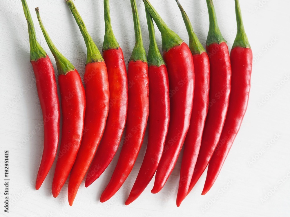 Red chili peppers in a raw. Culinary background. Top view. Red chili peppers in a raw. Culinary background. Top view.