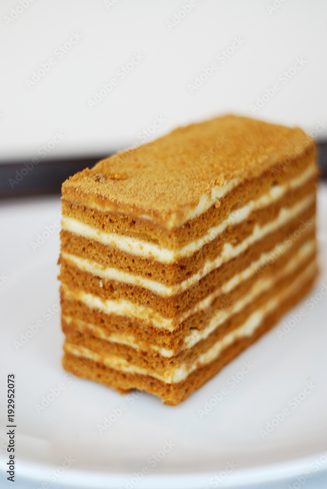 Piece of russian honey cake (Medovik) on neutral background. Piece of russian honey cake (Medovik) on neutral background.