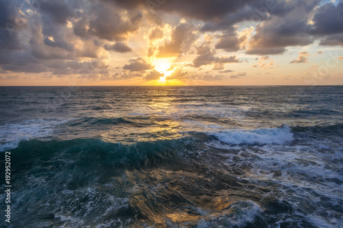 Fantastic stunning colorful sunset by the sea, waves and sunlight