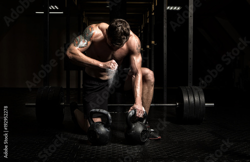 Muscular man workout with kettlebell