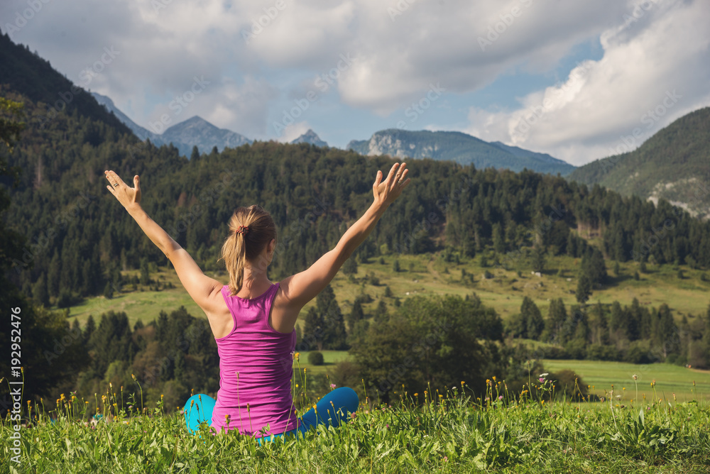 young woman meditate on top of the mountain young woman meditate on top of the mountain