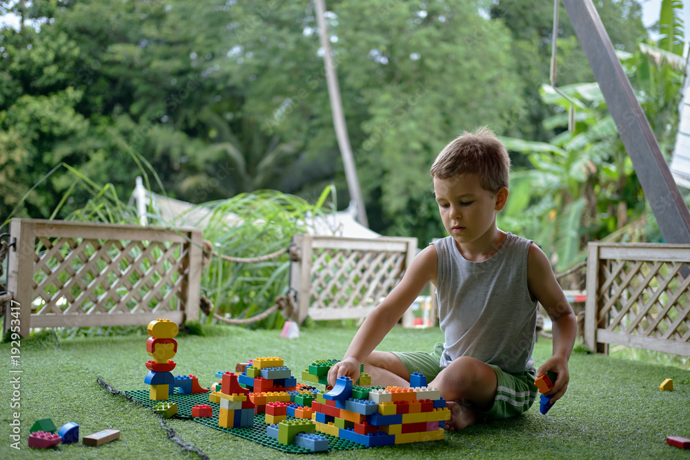 custom made wallpaper toronto digitalBoy playing with plastic construction toys. Amusement playground. Thailand