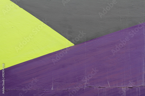 Colorful (black, violet and green) painted wall with cracks as background or texture
