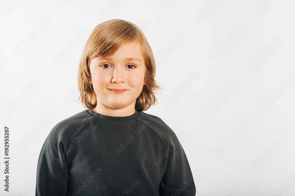 Studio shot of adorable little boy with long blond hair, wearing black sweatshirt Studio shot of adorable little boy with long blond hair, wearing black sweatshirt
