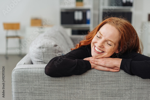 Young redhead woman reliving happy memories