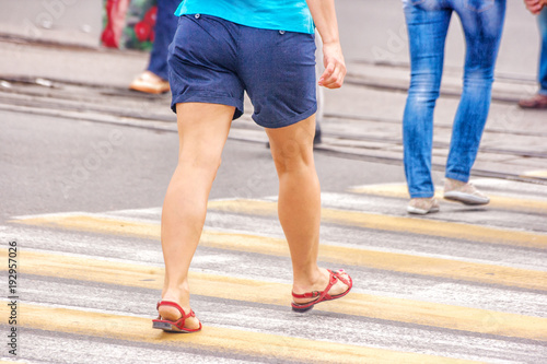 young woman feet, crossing an urban street © Radnatt