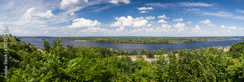 Panoramic view from mountain Tarasova in Kanev, Cherkassy region, on small island and hydroelectric dam on broad Dnieper in quiet evening summertime sunset