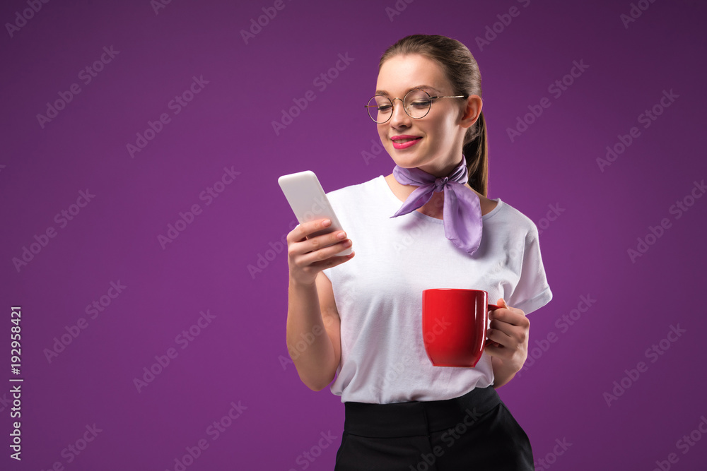 girl with red cup of coffee using smartphone isolated on purple girl with red cup of coffee using smartphone isolated on purple