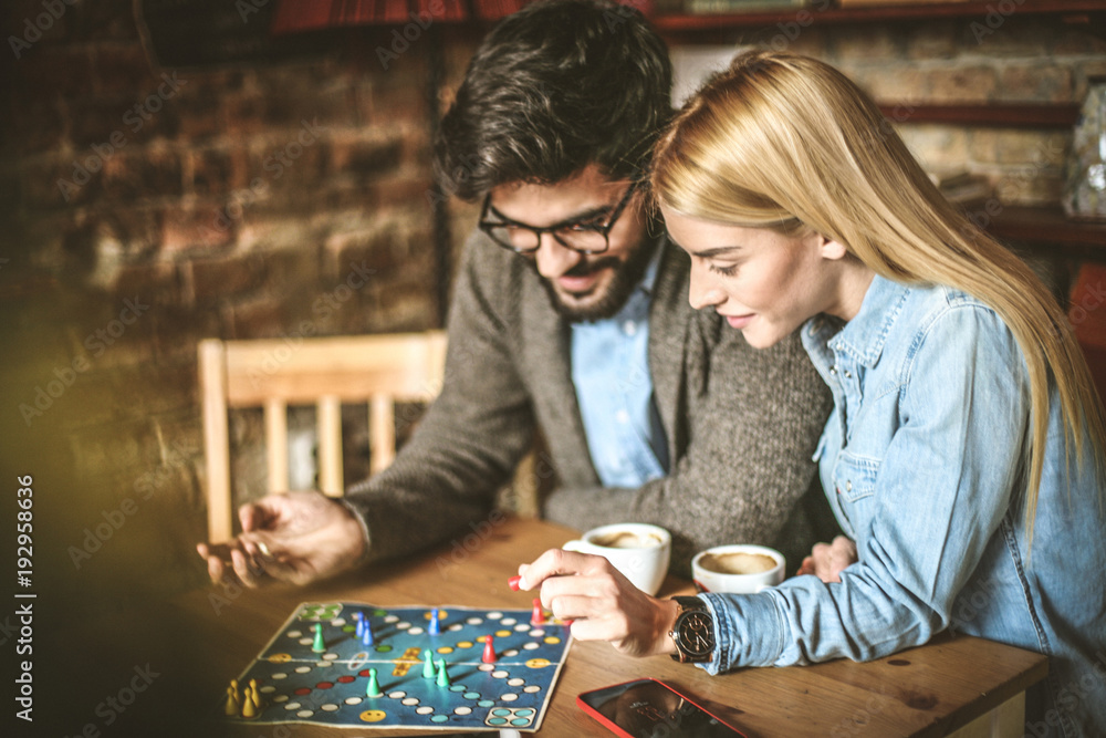 Fototapeta premium Young couple playing leisure games together.