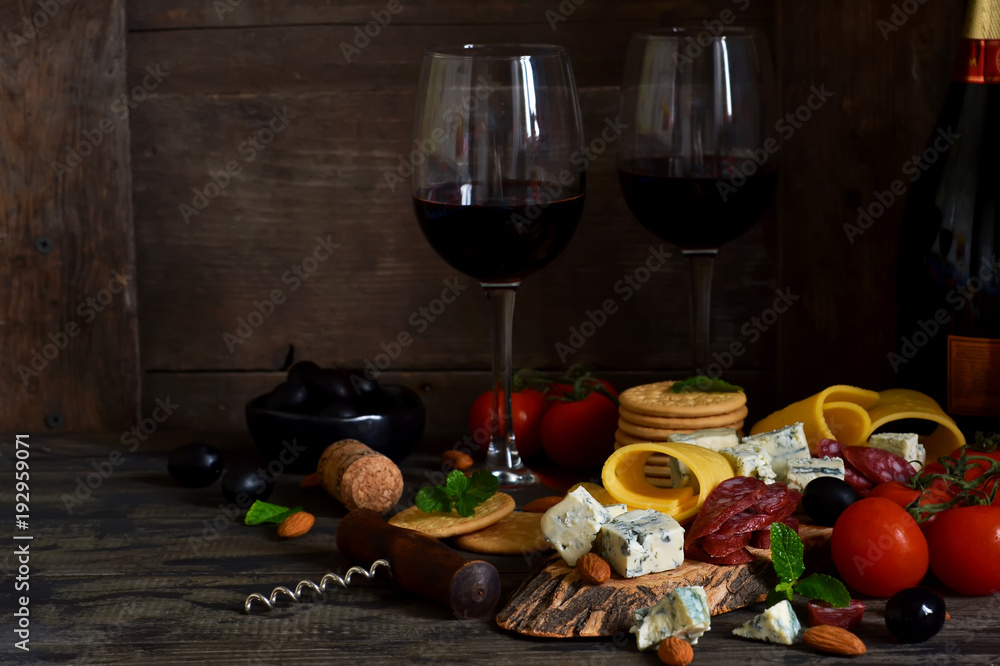 Snacks for wine: blue cheese, olives, salami. Delicacies. Rustic food background.