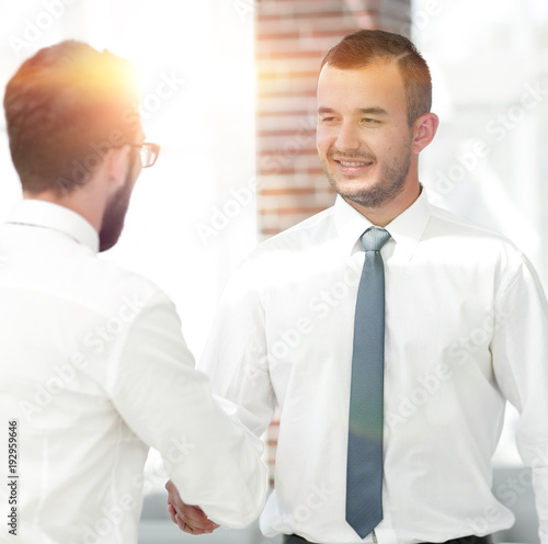 employees greet each other by shaking hands