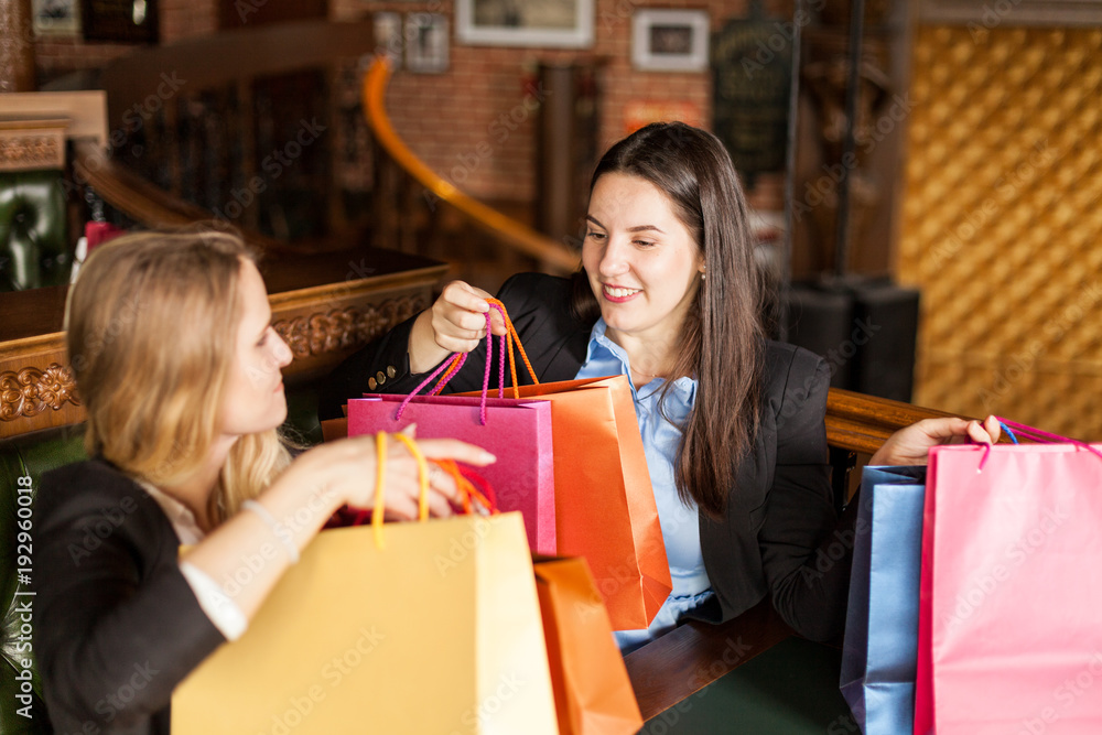 Happy young teenagers are inspired with clothes and products they purchased in a store Happy young teenagers are inspired with clothes and products they purchased in a store
