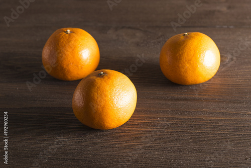  Mandarins on a dark wooden background