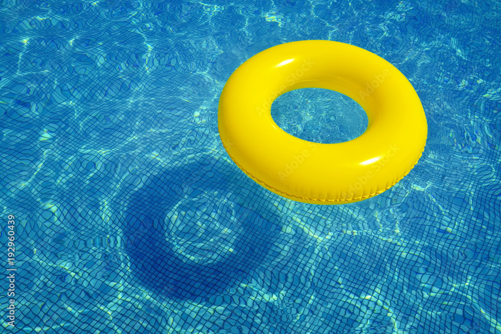 Colorful inflatable tube in swimming pool Colorful inflatable tube in swimming pool