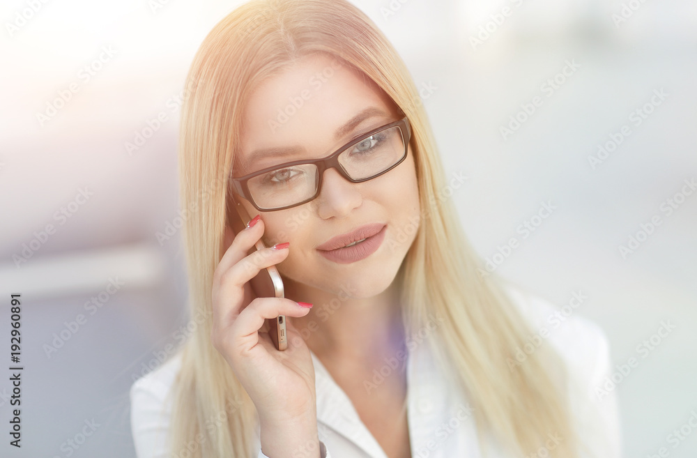 closeup of confident business woman talking on a mobile phone. closeup of confident business woman talking on a mobile phone.