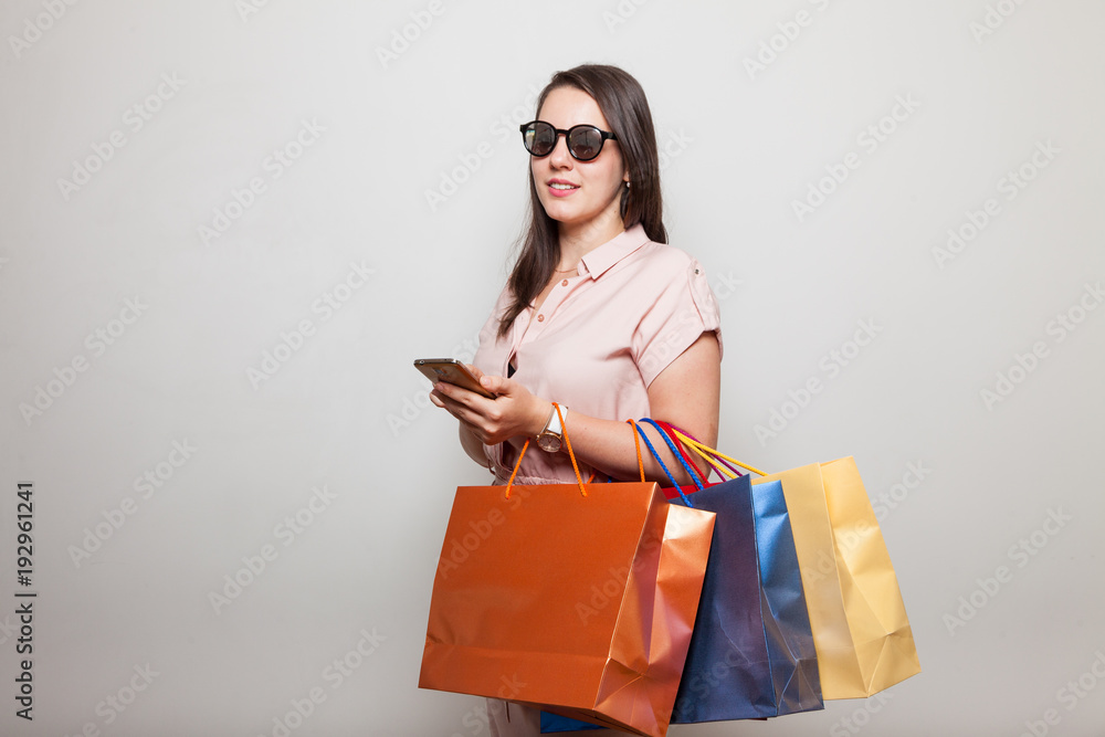 Portrait of a young girl standing with gift bags Portrait of a young girl standing with gift bags