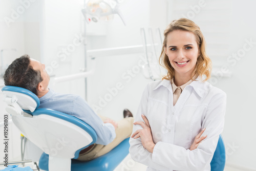 Female doctor with folded arms in modern dental clinic