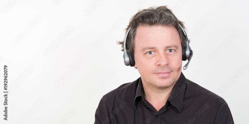 Portrait of a smiling attractive businessman with a headset on man head Portrait of a smiling attractive businessman with a headset on man head