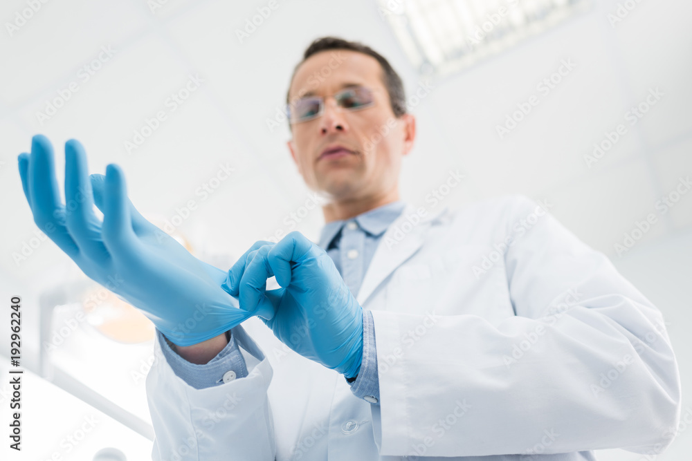 Doctor wearing medical gloves in modern  clinic