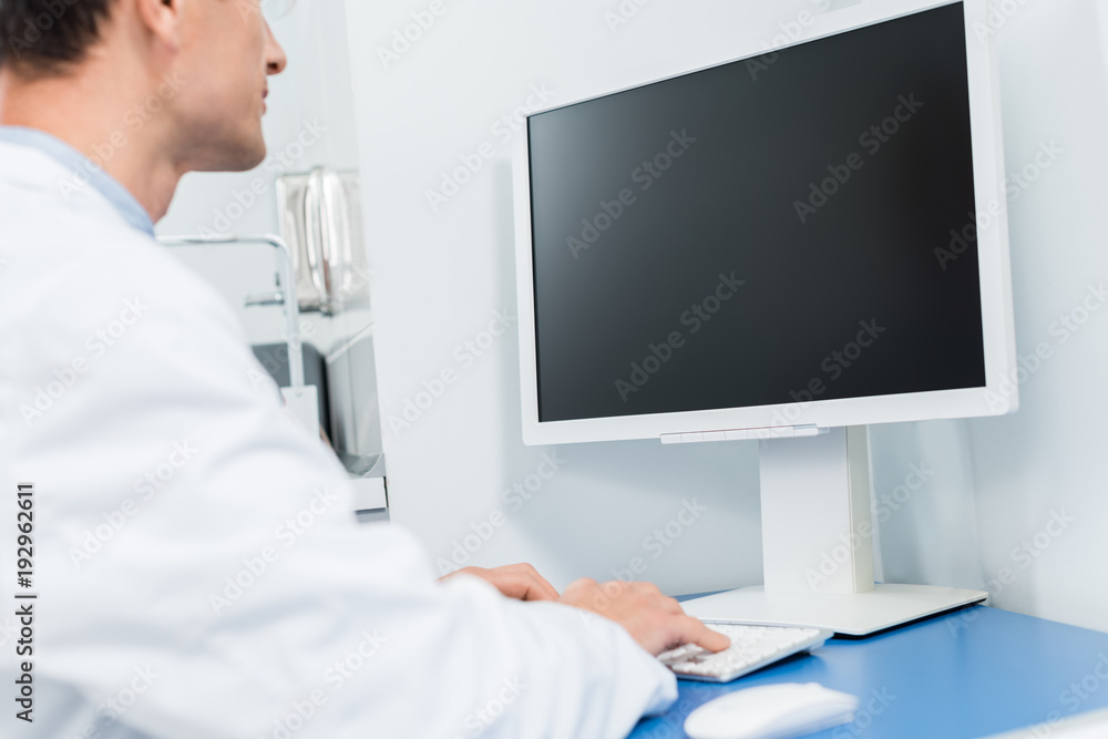 Doctor working by computer in modern clinic Doctor working by computer in modern clinic